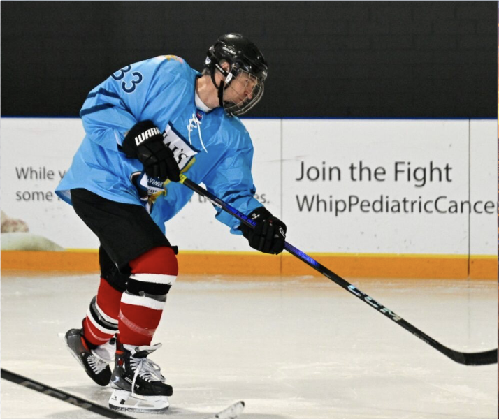 Hockey player skating on the ice at the Hockey for Harper charity tournament supporting pediatric cancer research