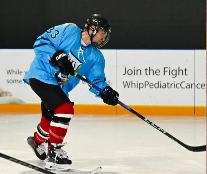 Hockey player skating on the ice at the Hockey for Harper charity tournament supporting pediatric cancer research