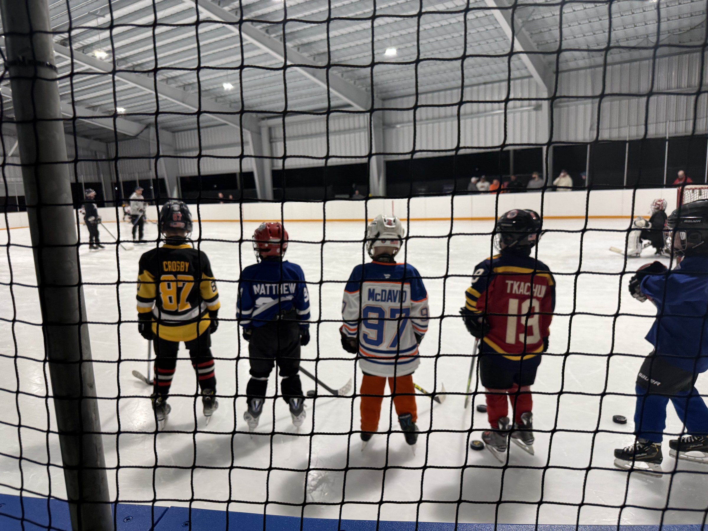 Young hockey players lined up on the ice at the Flexible Arena in Hauppauge, New York